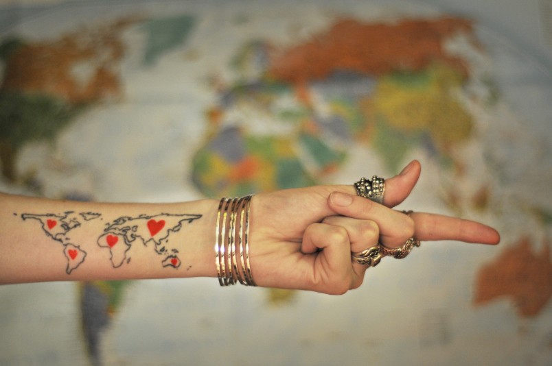 world map outline tattoo arm