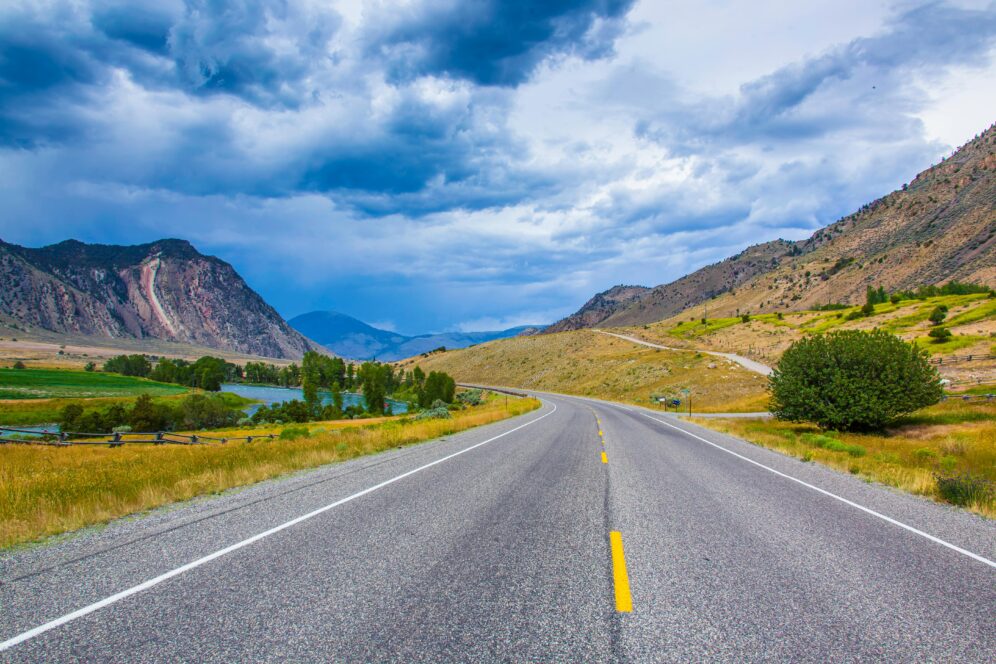 Scenic highway through mountain valley landscape.