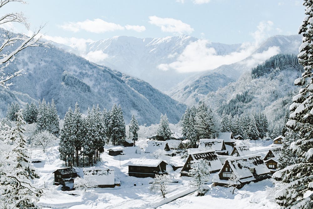Snowy village on mountain landscape.
